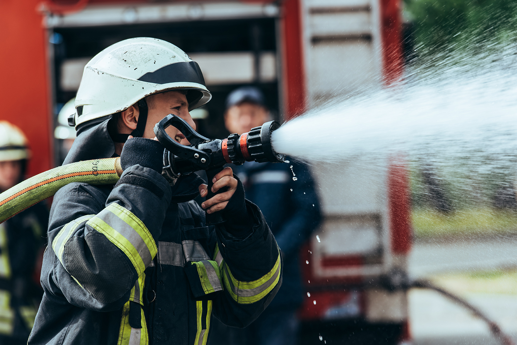 selective focus of firefighter with water hose ext 2022 12 16 15 44 19 utc
