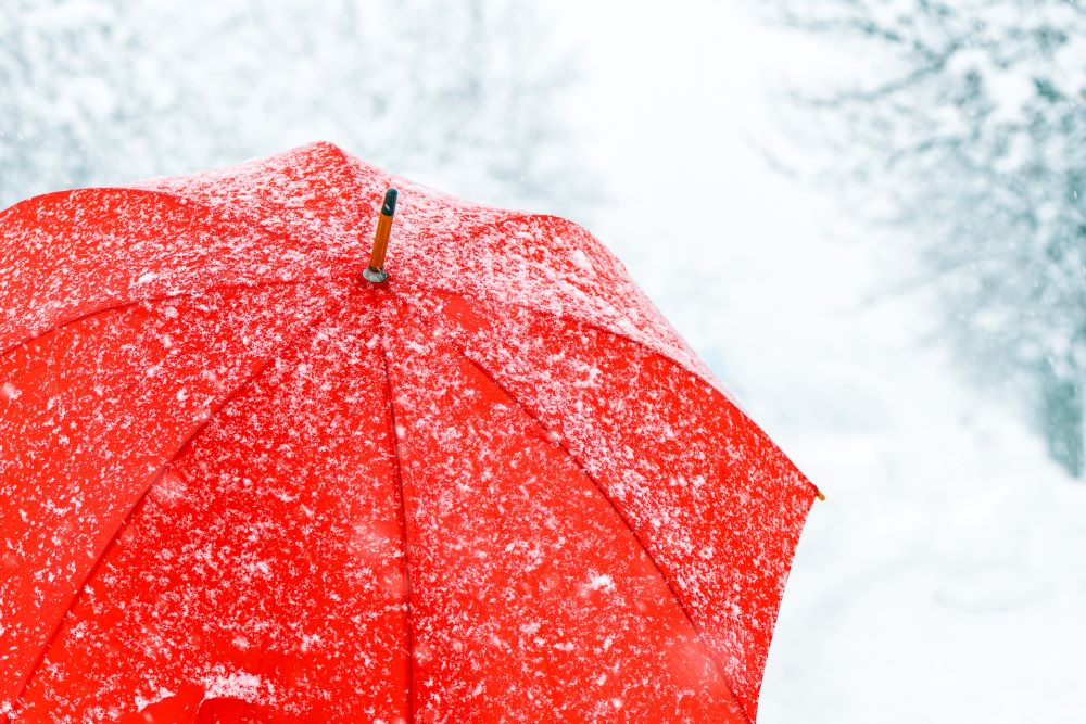 close up of red umbrella in snow copy