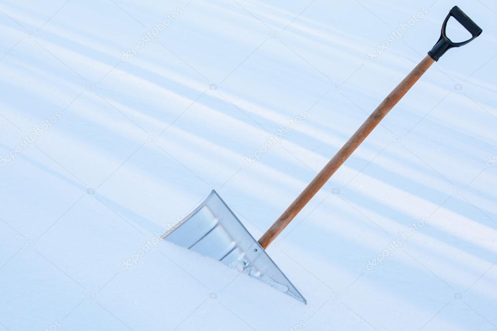depositphotos 101770448 stock photo snowshovel in the snowdrift closeup
