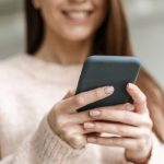 portrait young business woman with mobile 1 1300x820