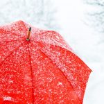 close up of red umbrella in snow copy