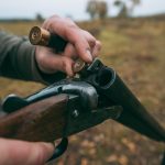 cropped image of hunter loading a gun with bullets 2022 12 16 20 42 09 utc