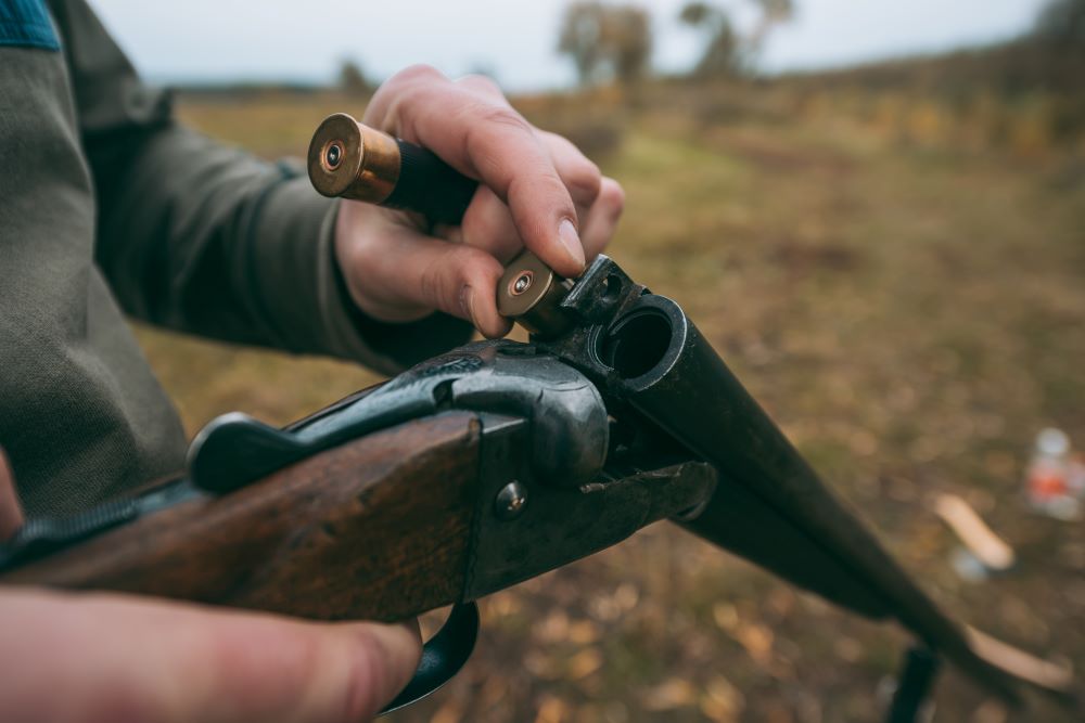 cropped image of hunter loading a gun with bullets 2022 12 16 20 42 09 utc