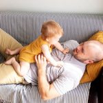 a man with a child playing