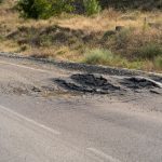 deformed asphalt with potholes