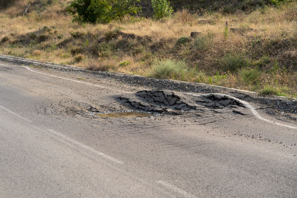 deformed asphalt with potholes