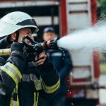selective focus of firefighter with water hose ext 2022 12 16 15 44 19 utc
